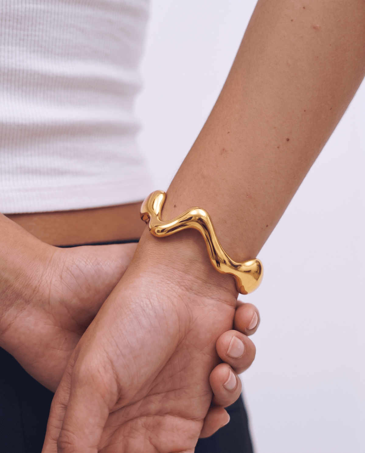 Gold-tone cuff bracelet with wavy design in Gold