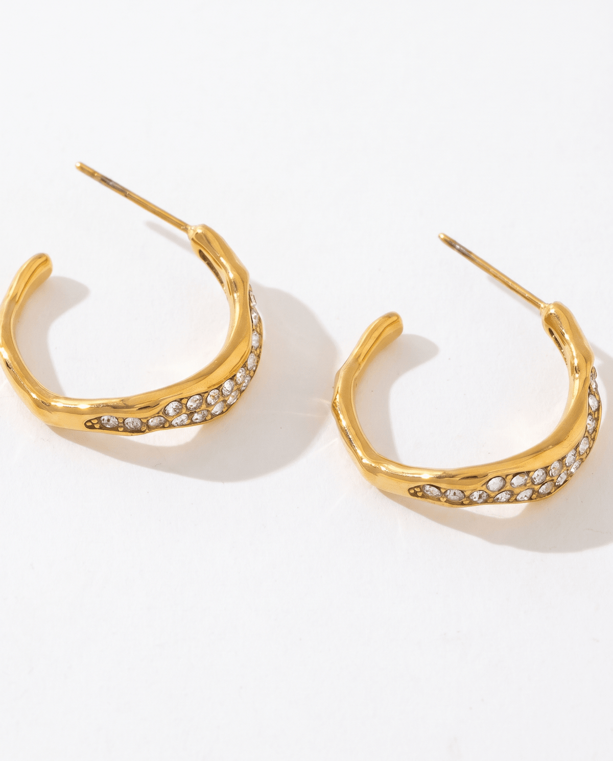 Gold-tone wavy hoop earrings with pave stones in Gold