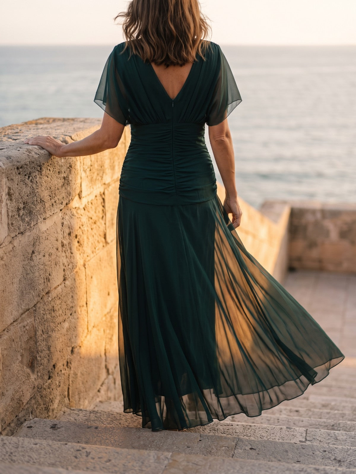 Occasion & Wedding Guest – green chiffon maxi dress on sandstone steps by the sea