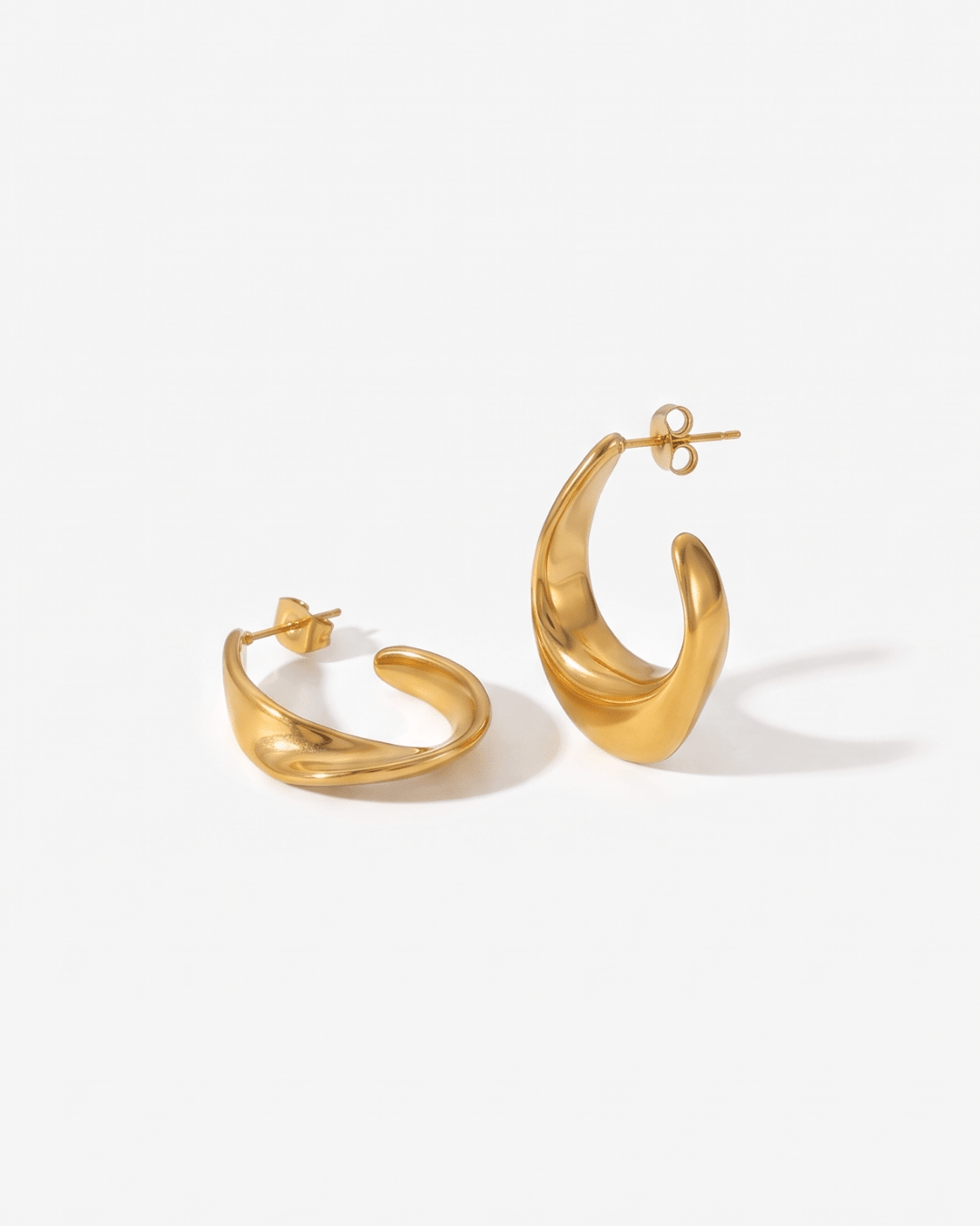 Chunky gold hoop earrings dome shape flat lay