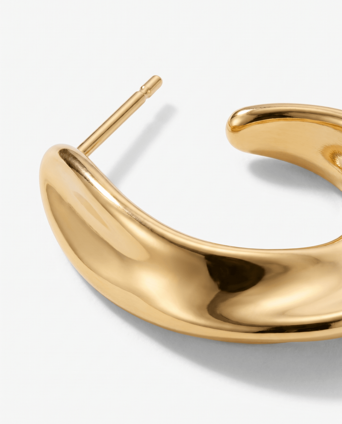 Chunky gold hoop earrings close-up of the gold-tone finish