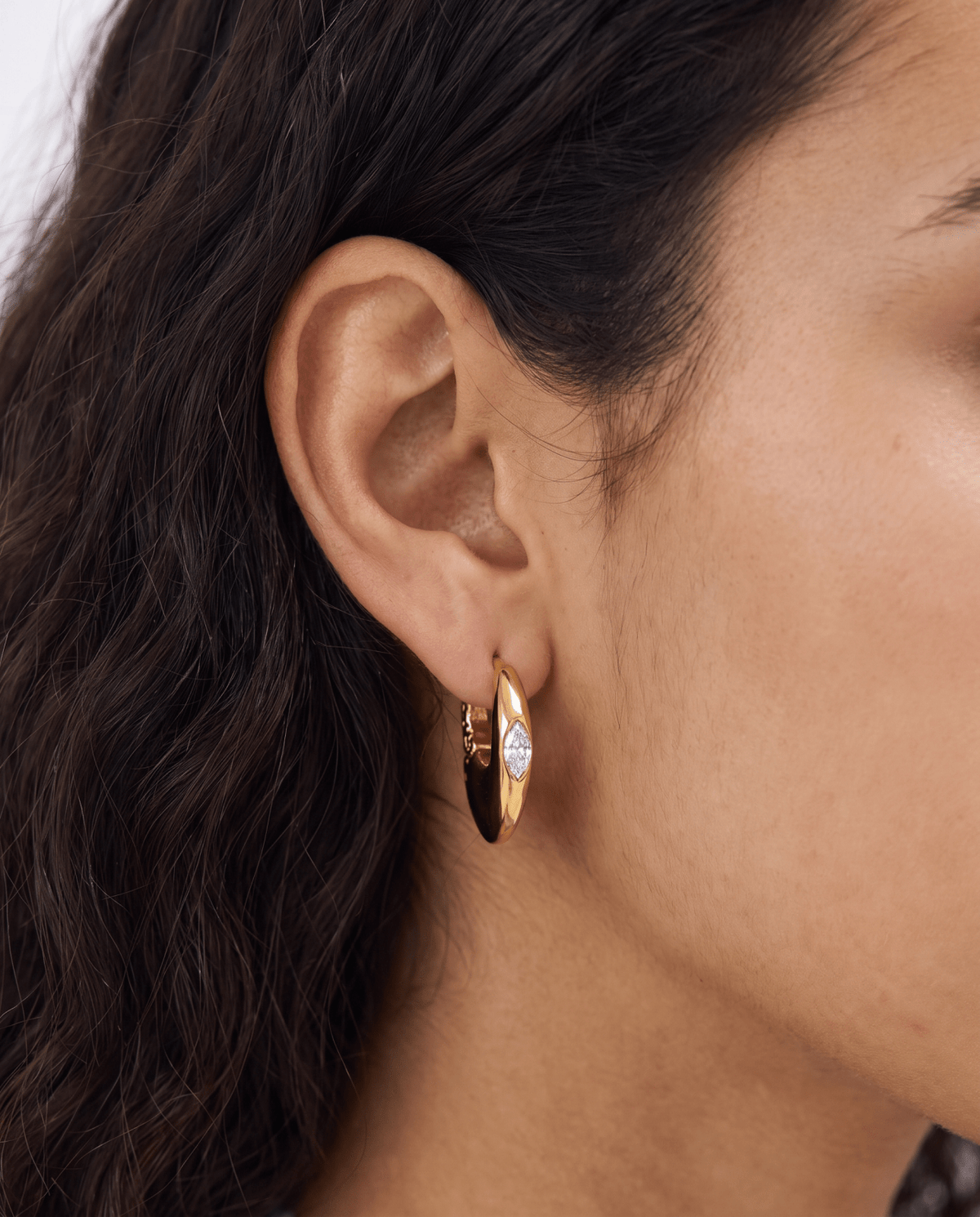 Chunky gold-tone huggie earrings with marquise stone