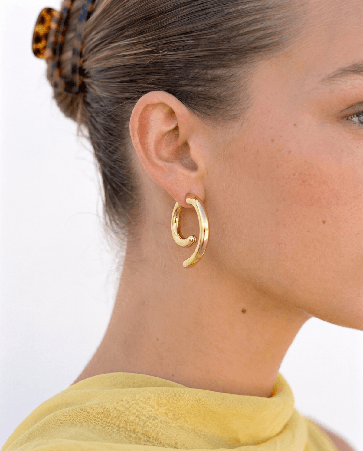 Chunky gold-tone spiral earrings with sculpted curve in Gold