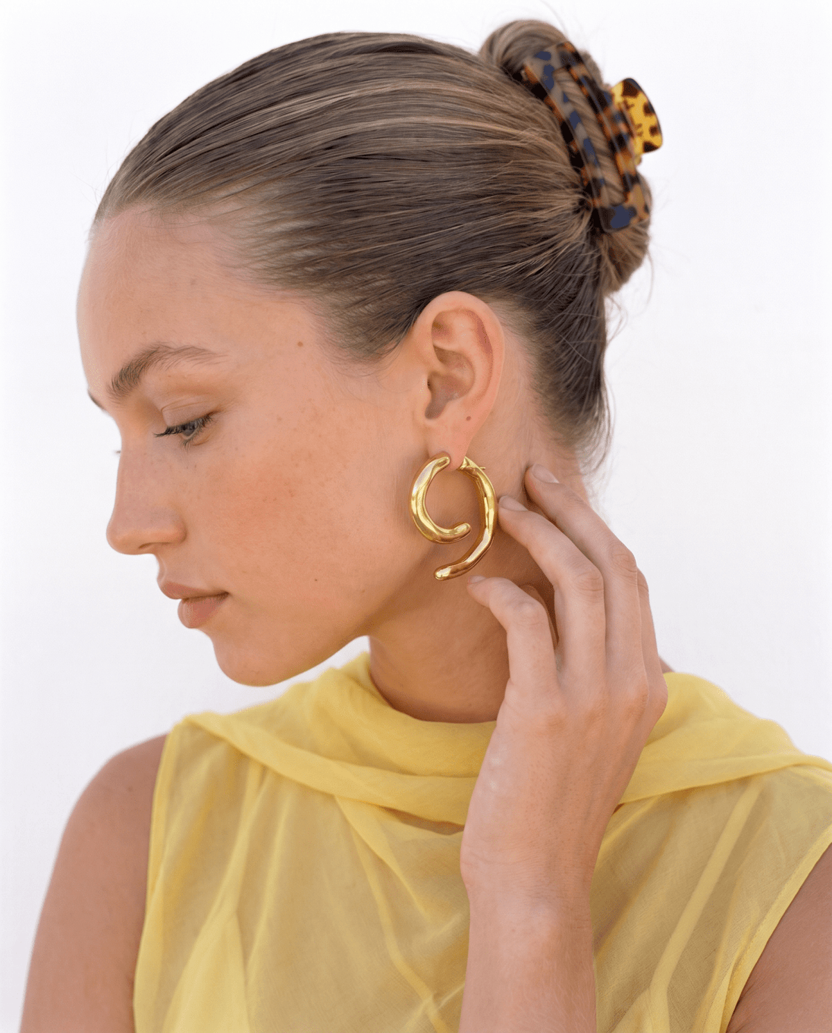 Chunky gold-tone spiral earrings with sculpted curve in Gold
