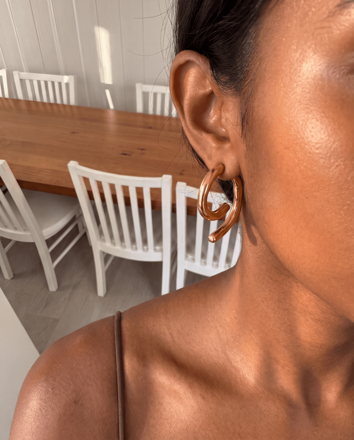 Chunky gold-tone spiral earrings with sculpted curve in Gold