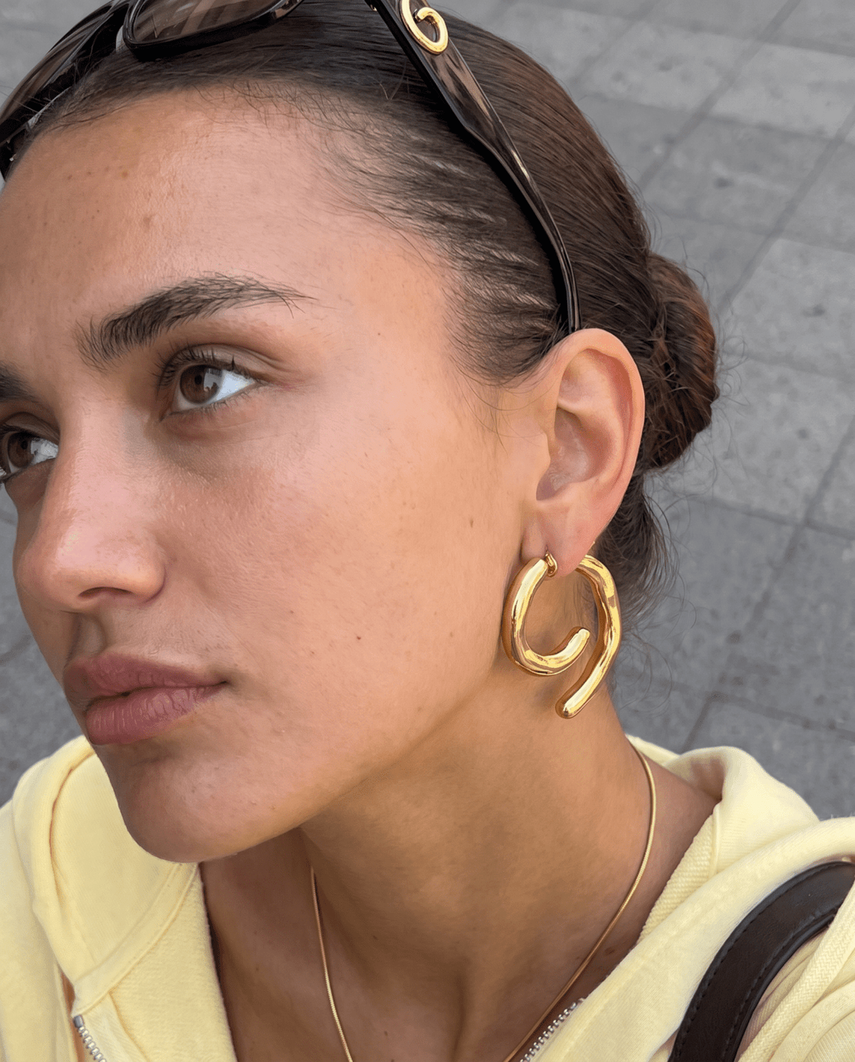 Chunky gold-tone spiral earrings with sculpted curve in Gold
