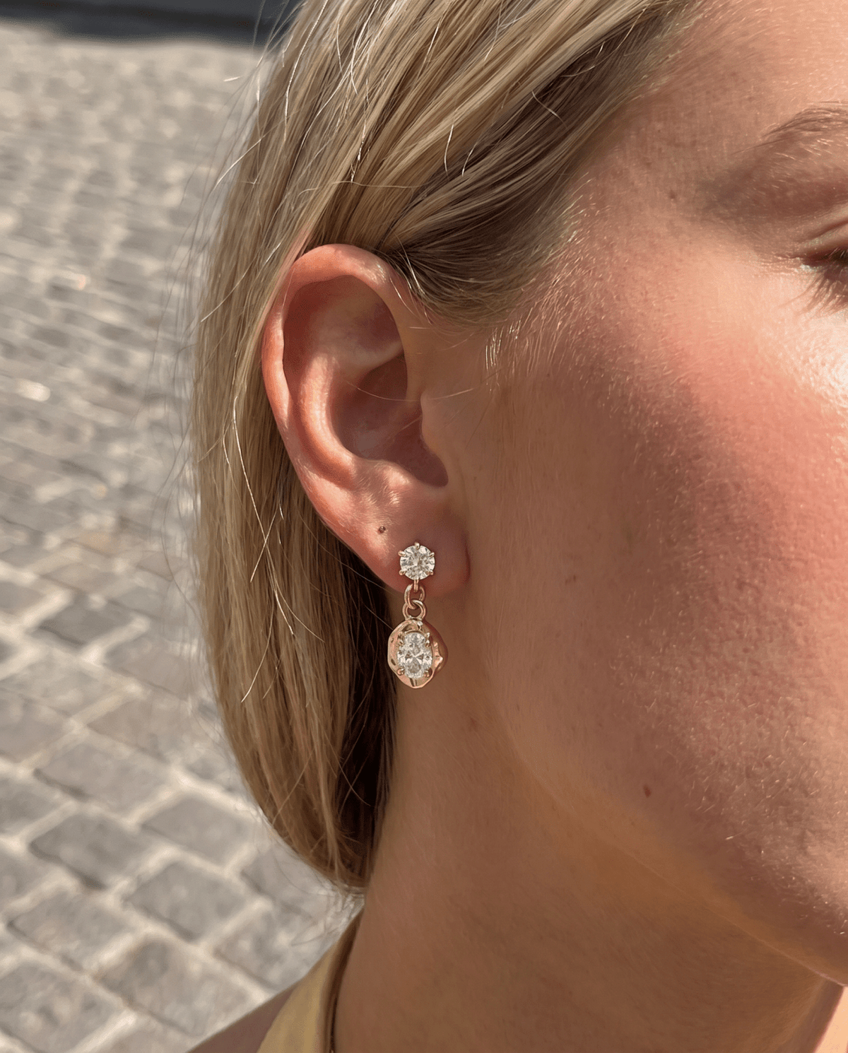 Crystal drop earrings worn, gold tone
