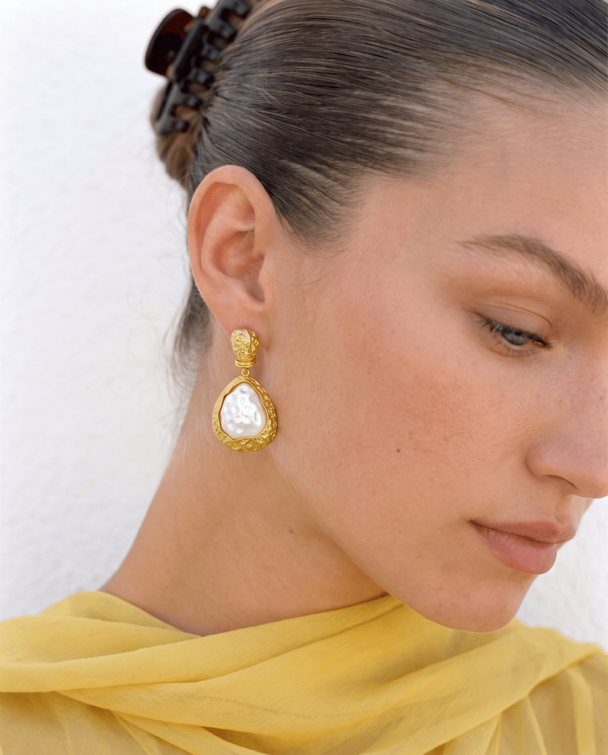 Pearl drop earrings gold tone side view on model