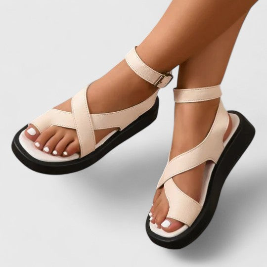 Flat sandals with toe loop and ankle strap in beige