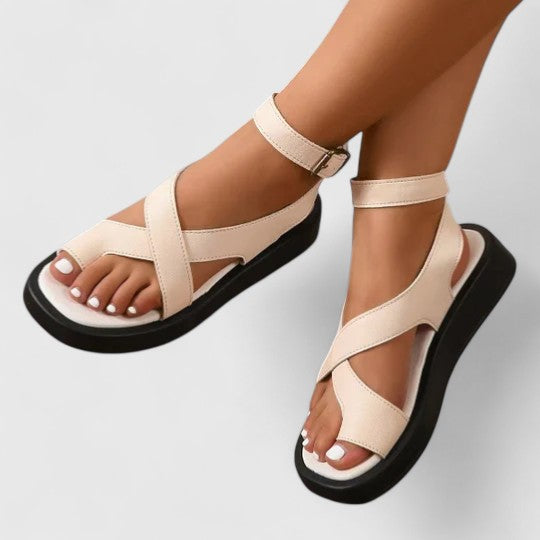 Flat sandals with toe loop and ankle strap in beige