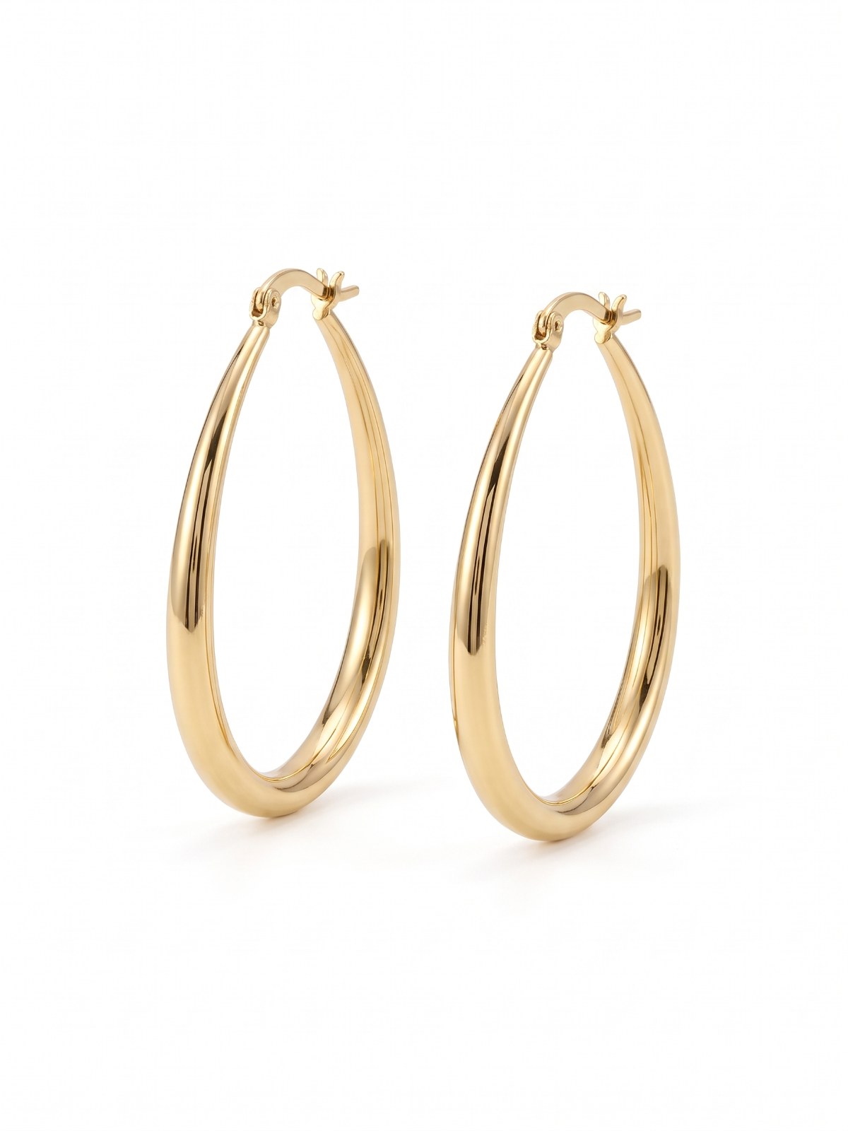 Gold oval hoop earrings on a white background