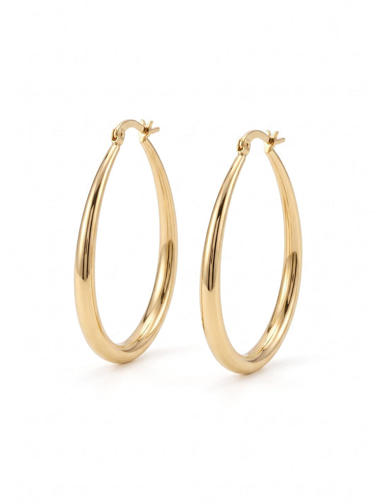Gold oval hoop earrings on a white background