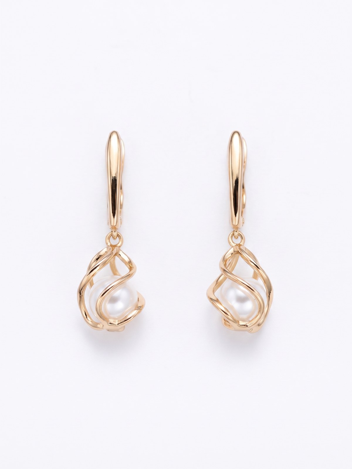 Gold drop earrings with pearl detail on a white background