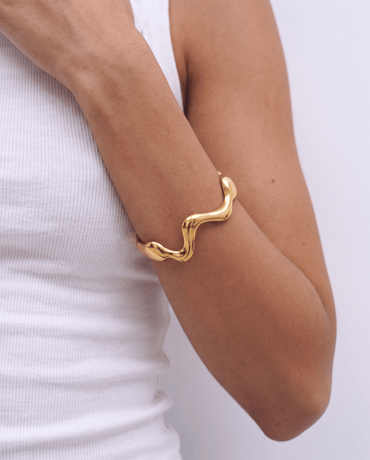 Gold-tone cuff bracelet with wavy design in Gold