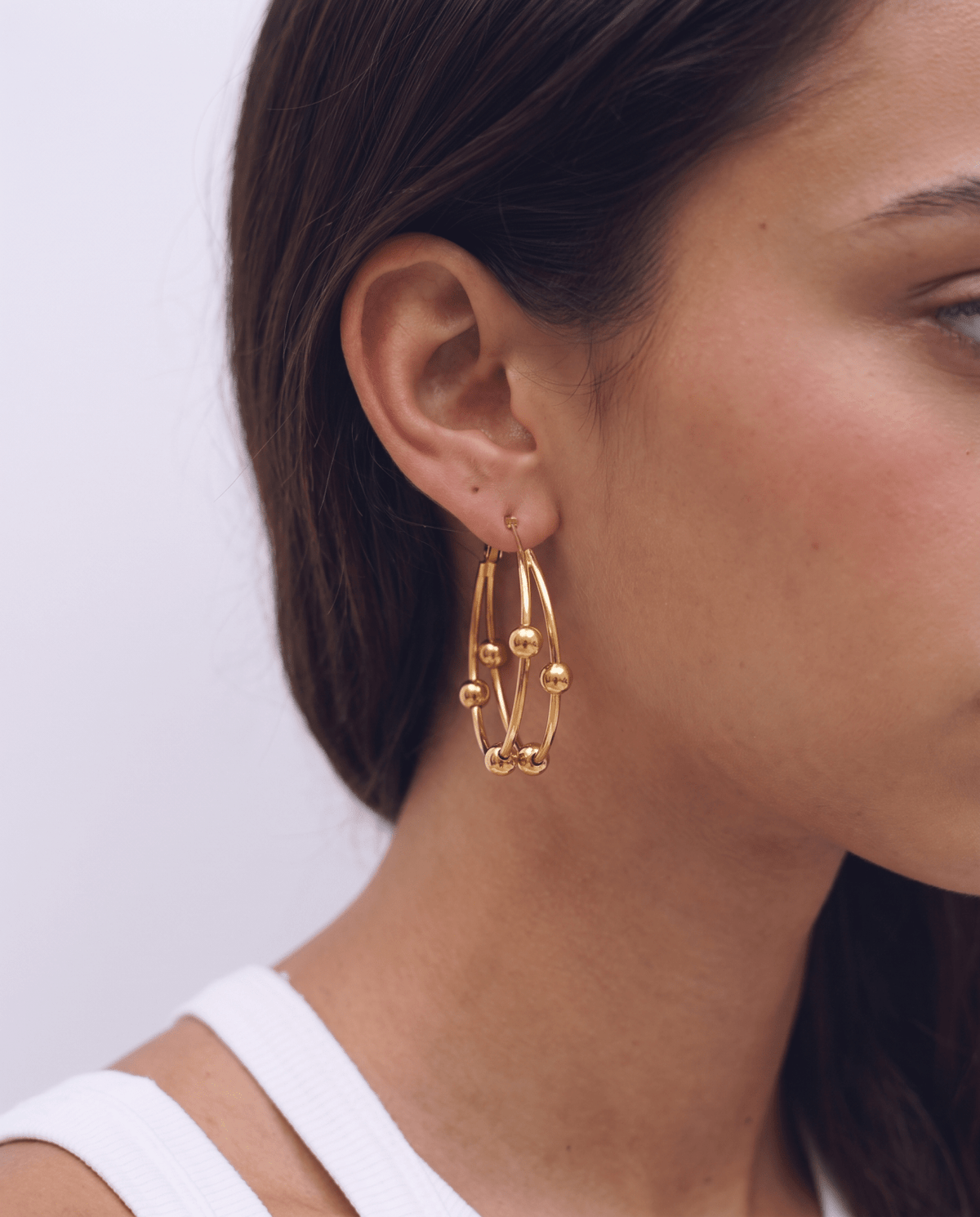 Gold-tone double hoop earrings with sliding beads in Gold