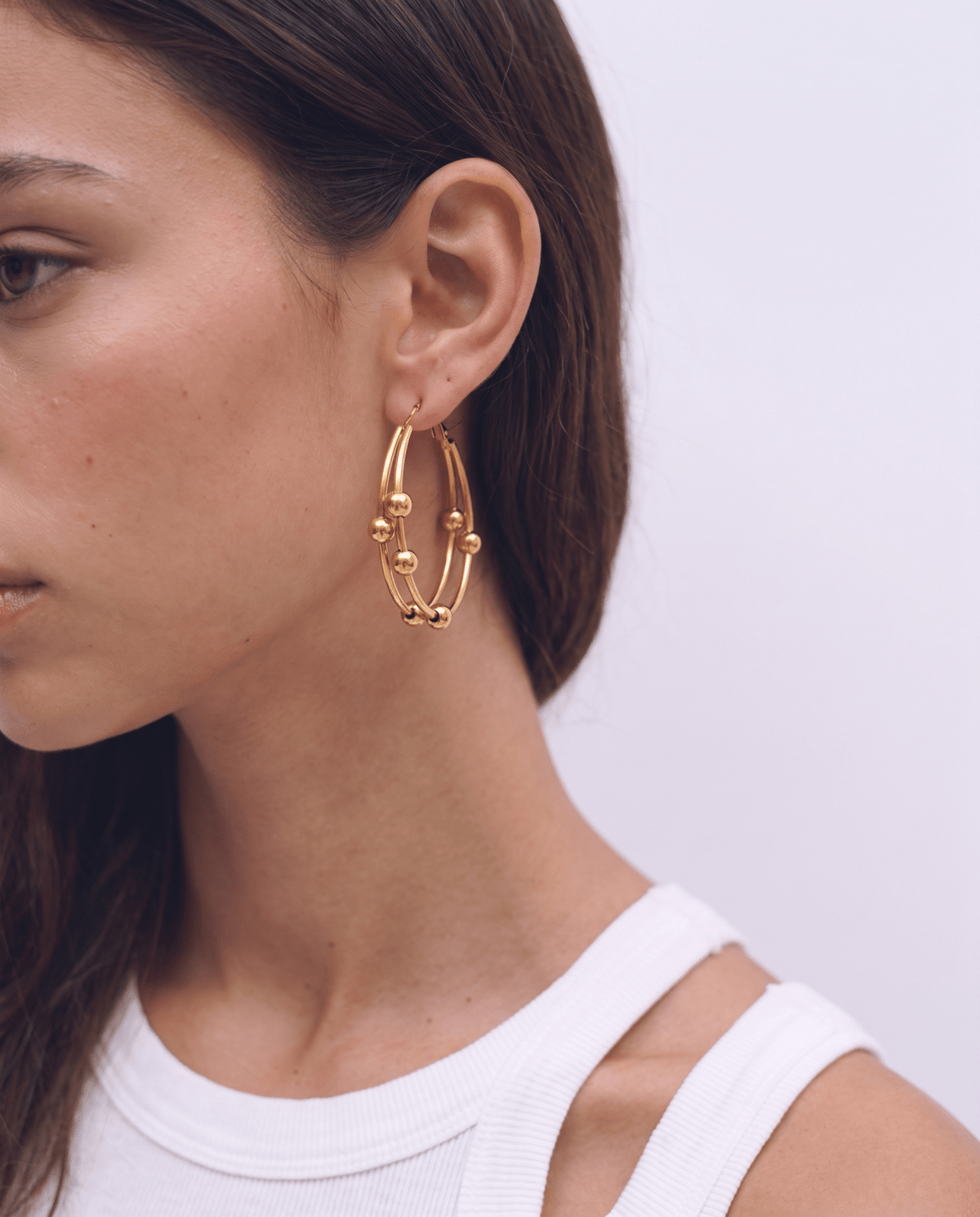 Gold-tone double hoop earrings with sliding beads in Gold