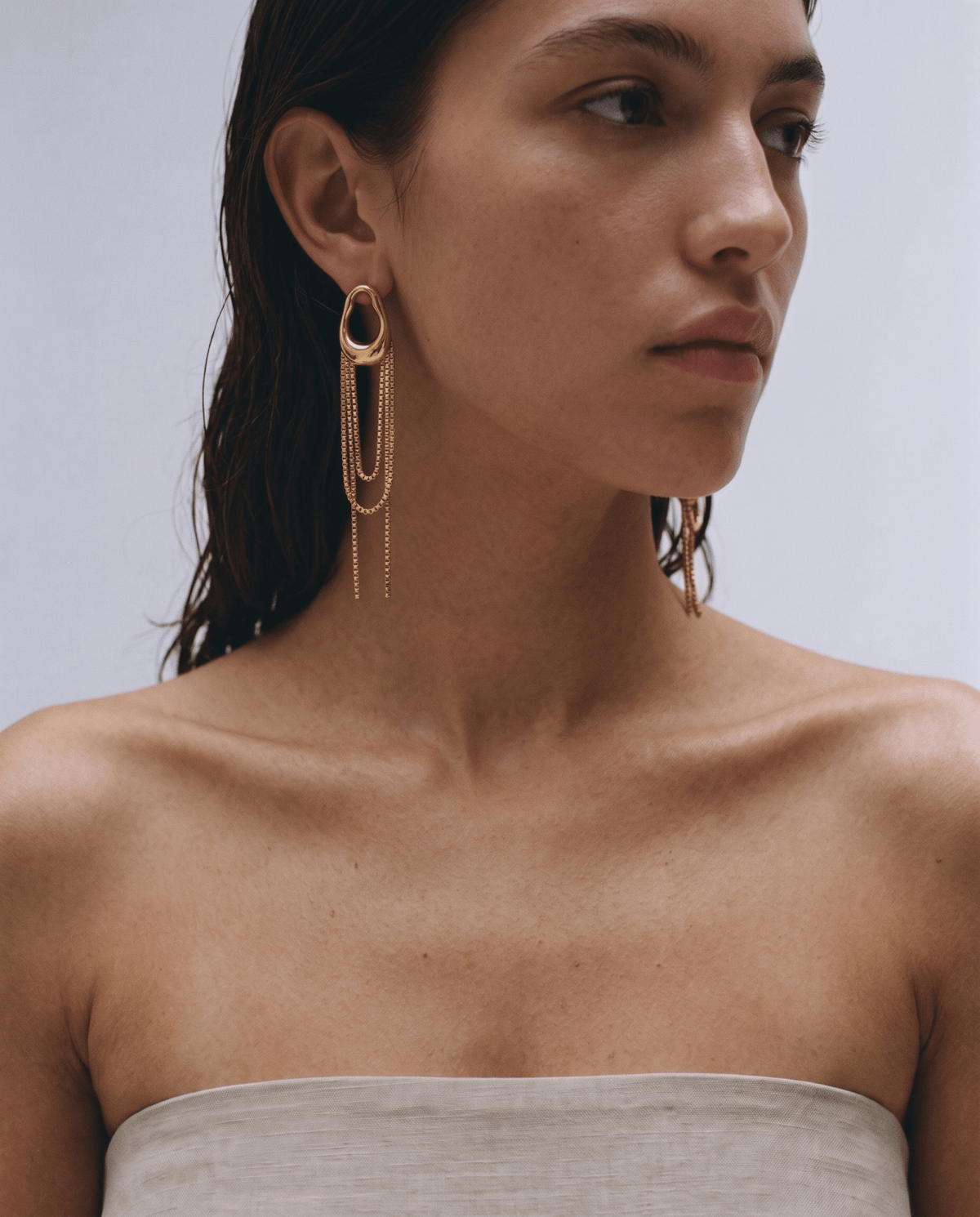 Gold-tone drop earrings worn, chain fringe