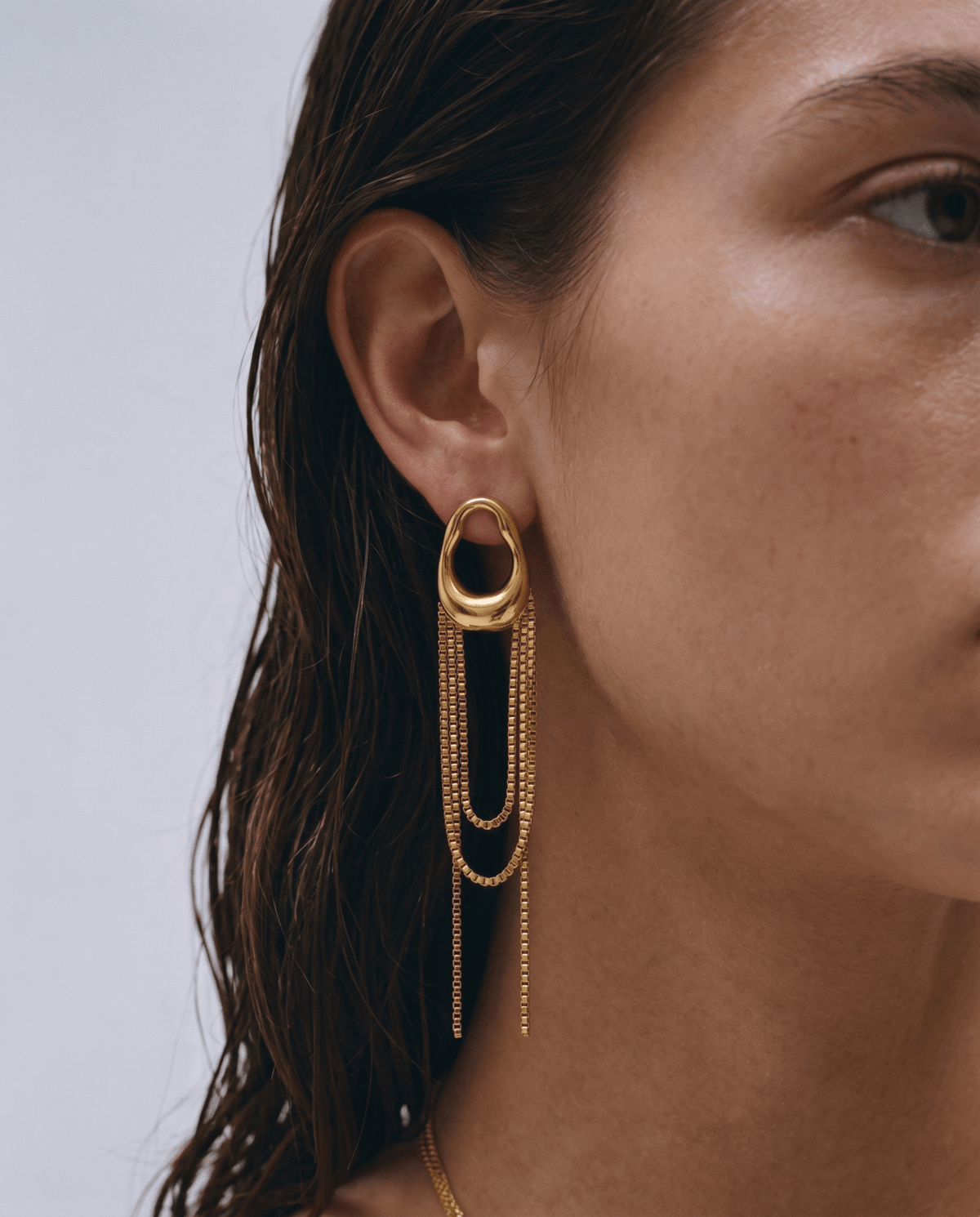 Gold-tone drop earrings side view