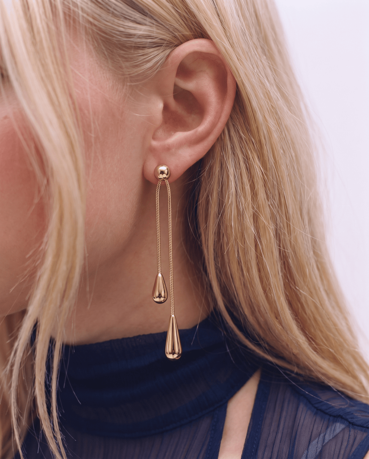 Gold-tone drop earrings with long teardrop design in Gold