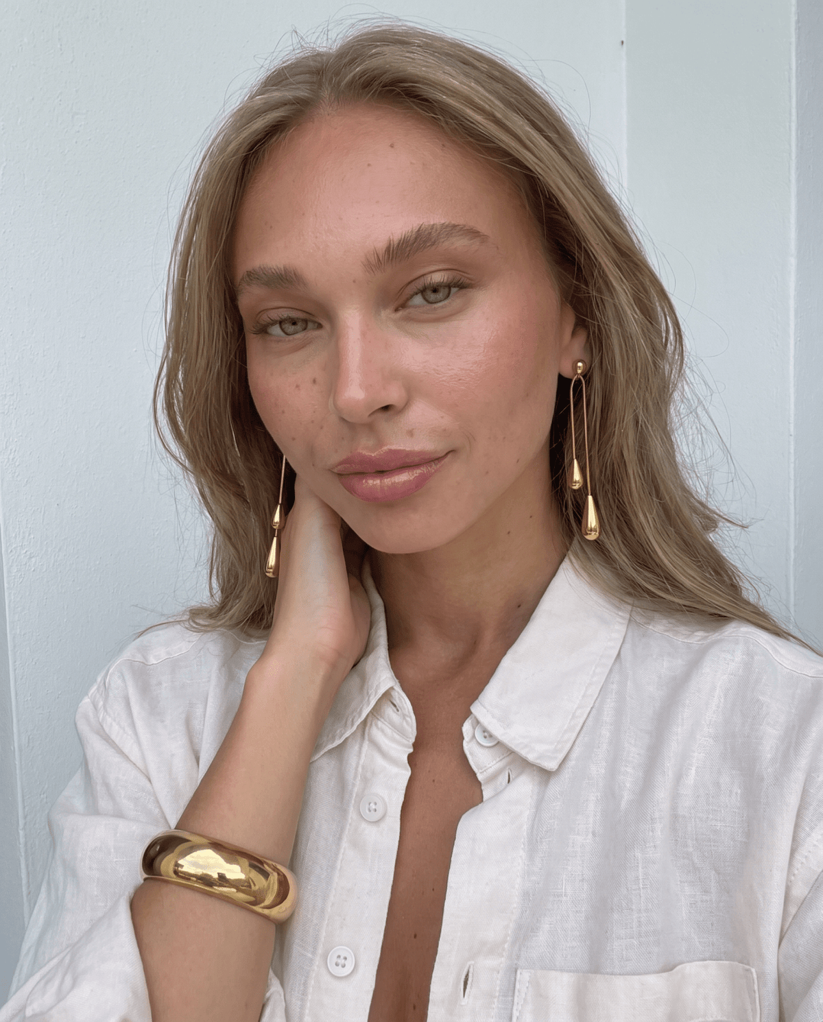 Gold-tone drop earrings with long teardrop design in Gold