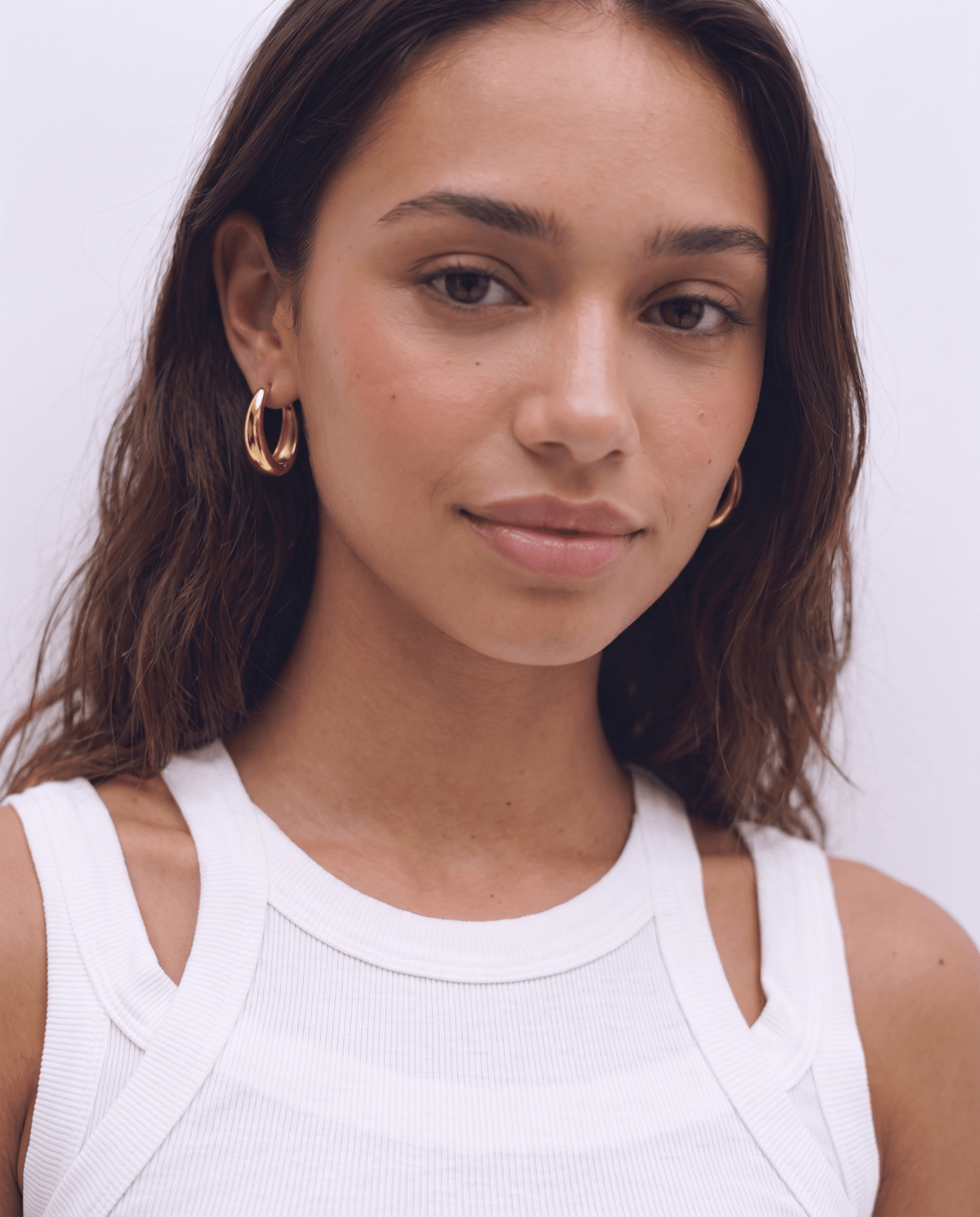 Gold-tone hoop earrings with chunky oval shape in gold
