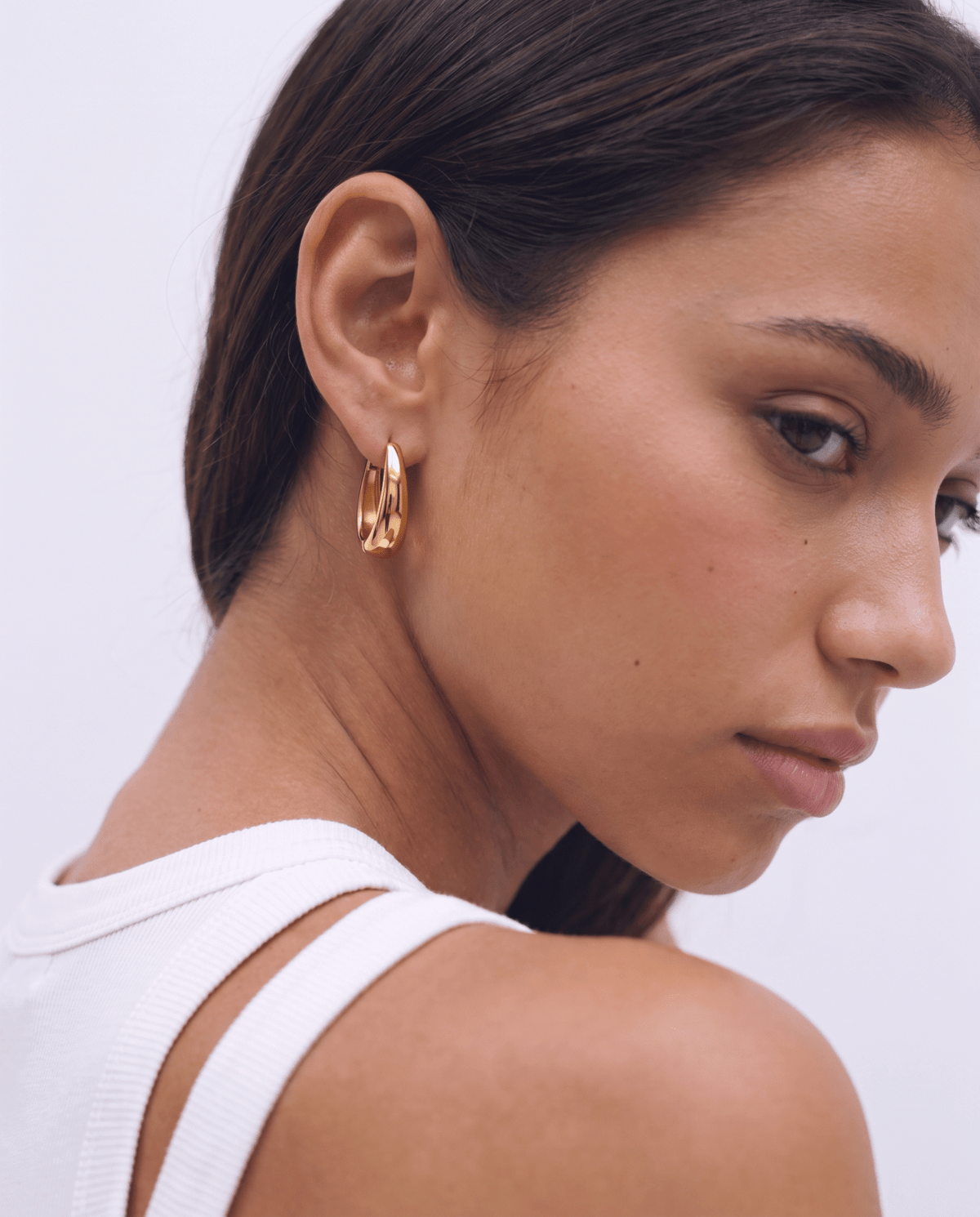 Gold-tone hoop earrings with chunky oval shape in gold