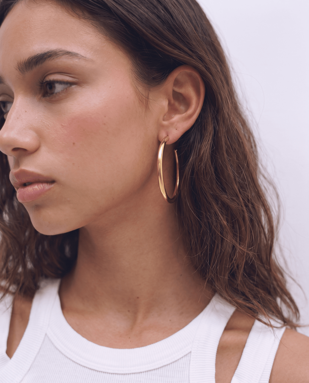 Gold-tone hoop earrings with classic round shape in Gold