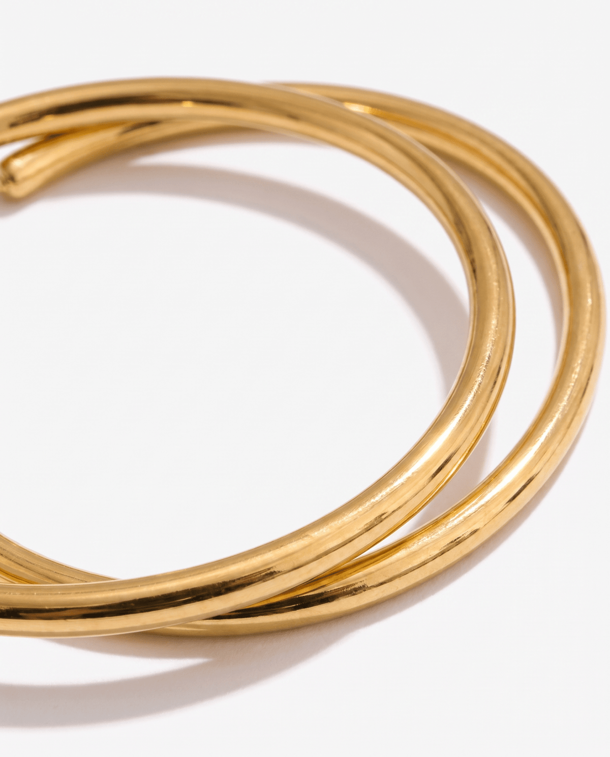 Gold-tone hoop earrings with classic round shape in Gold