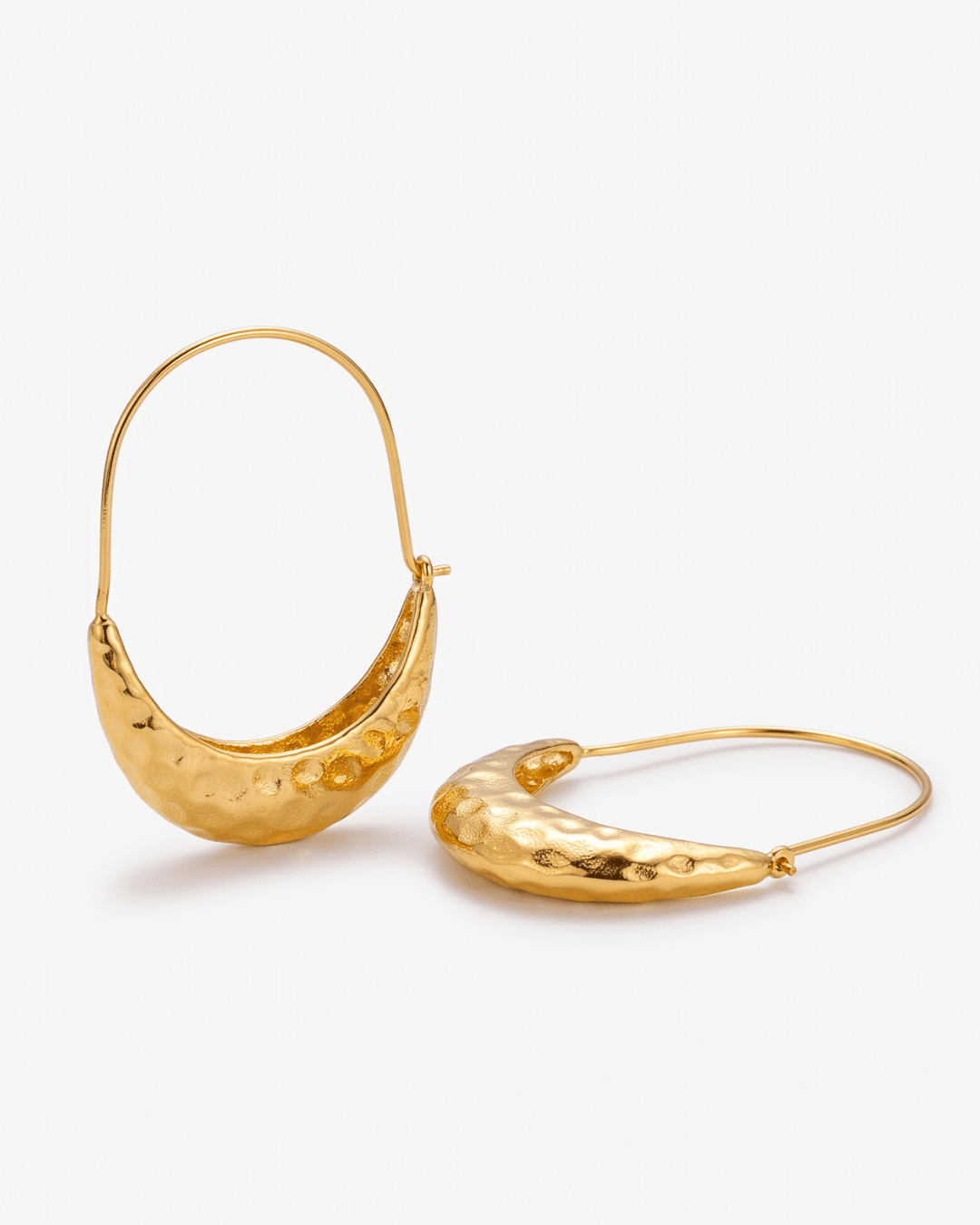 Gold crescent hoop earrings flat lay