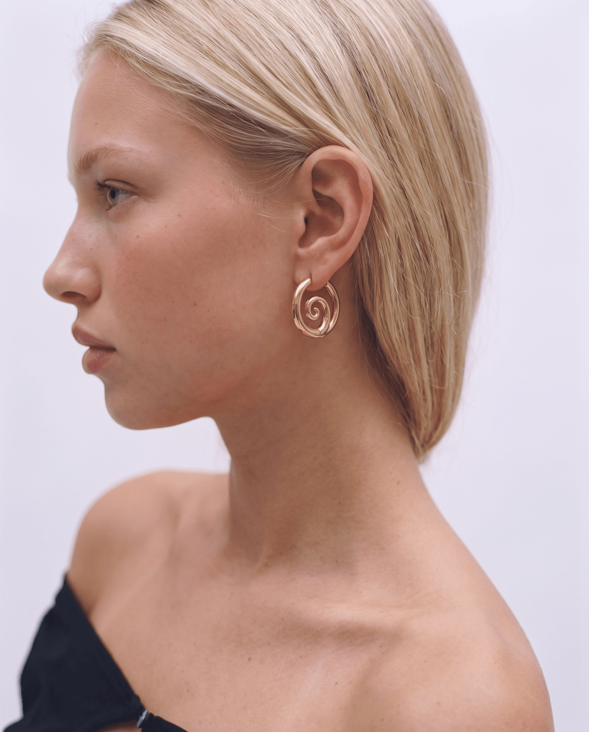 Gold-tone hoop earrings with twisted spiral front in Gold