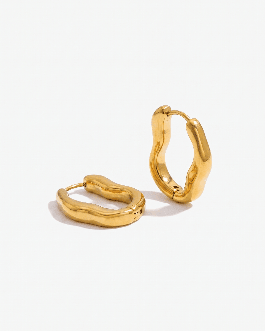 Gold huggie earrings chunky wavy flat lay