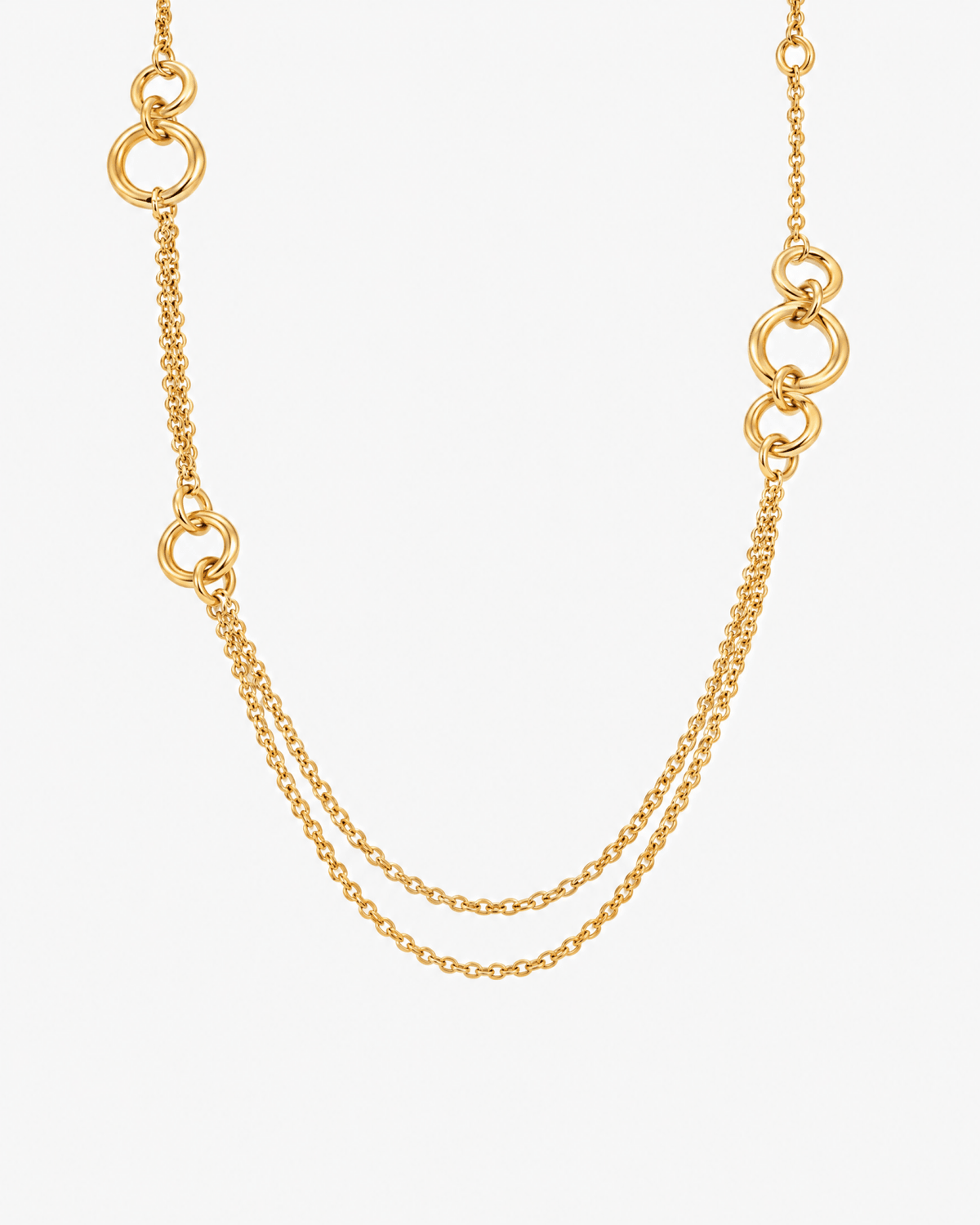 Gold layered necklace with double chain and link rings in gold tone