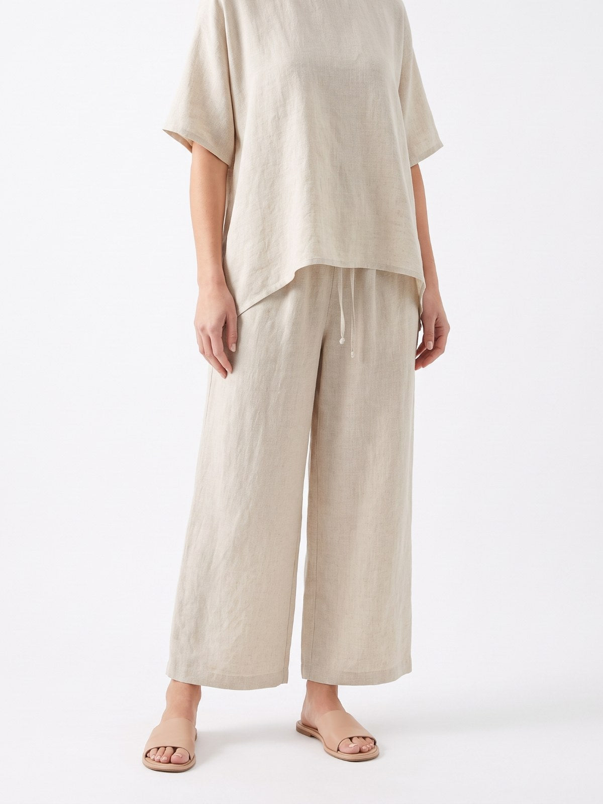 Ecru linen asymmetric top and pants set on a white background