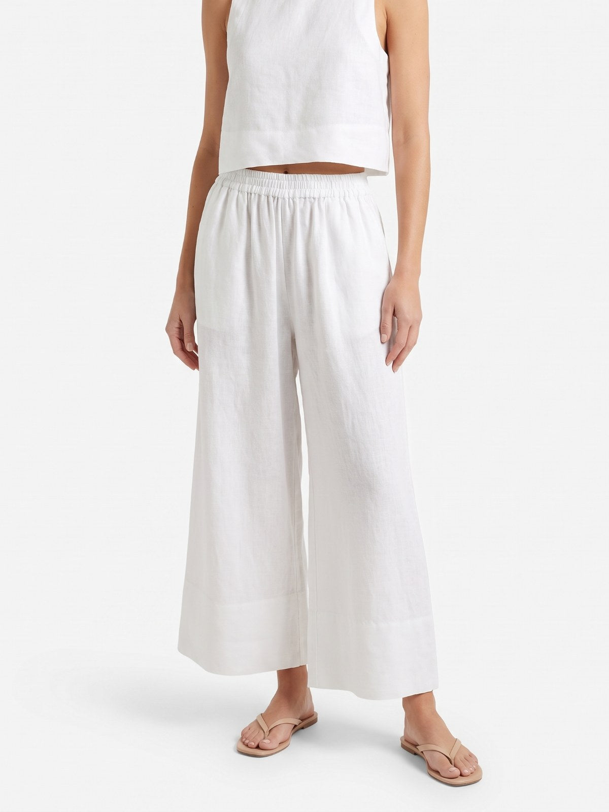 White linen crop top and wide-leg pants set on a white background