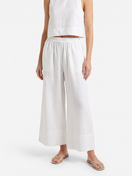 White linen crop top and wide-leg pants set on a white background