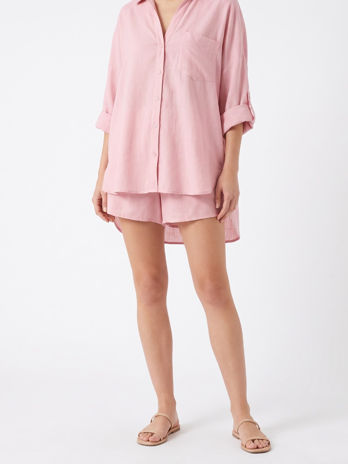 Pink cotton-linen shirt and shorts set on a white background