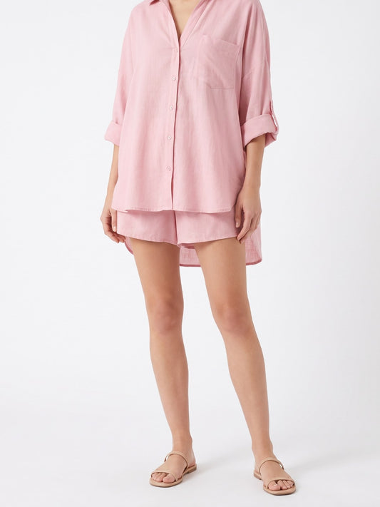 Pink cotton-linen shirt and shorts set on a white background