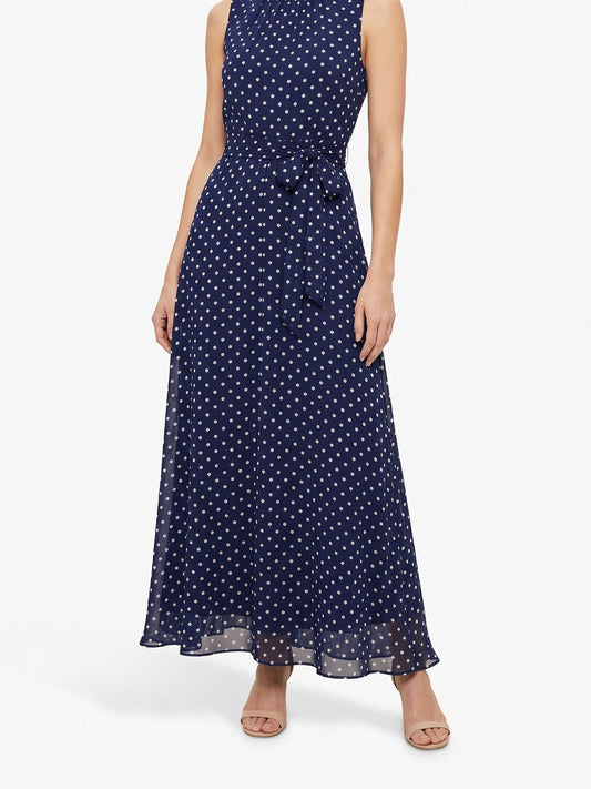 Navy polka dot sleeveless maxi dress with ruffle hem on a white background