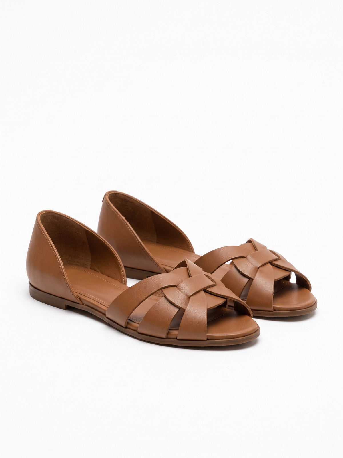 Brown woven cross-strap flat sandals on a white background
