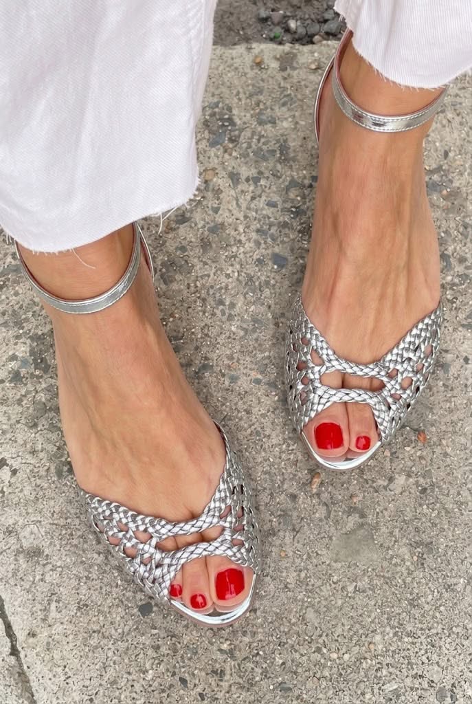 Woven peep-toe flat sandals in silver - worn