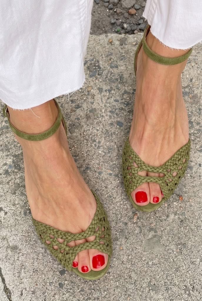 Woven peep-toe flat sandals in olive green - worn