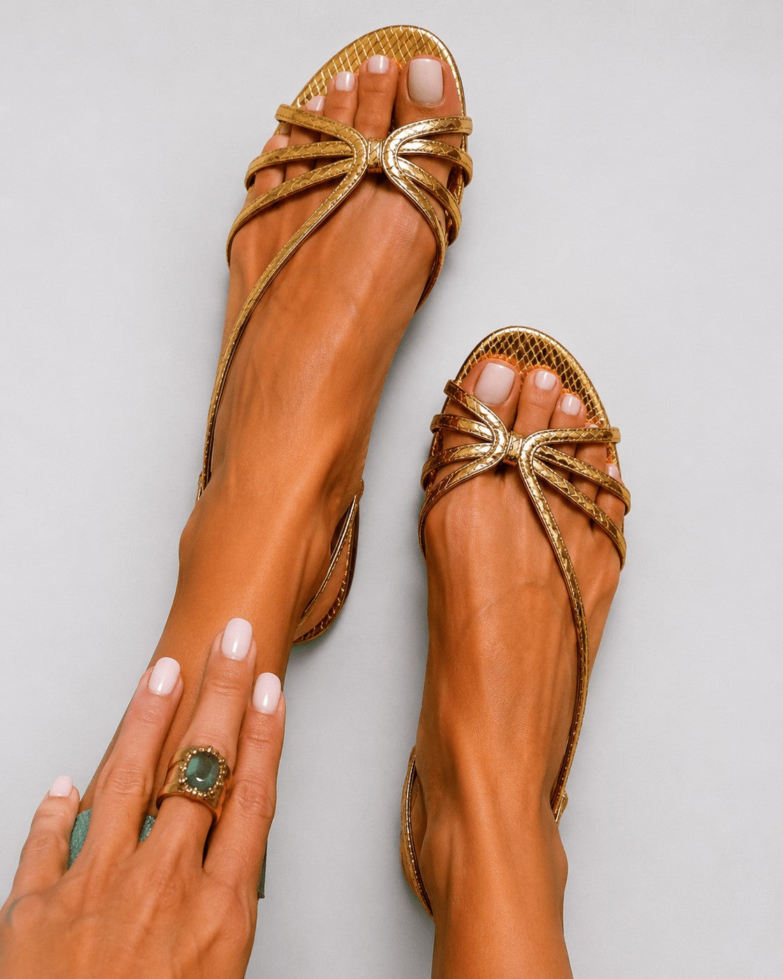Strappy flat sandals in gold – worn