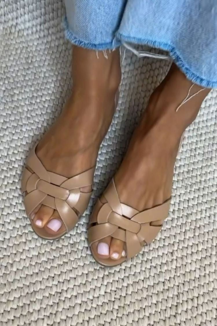Woven cross-strap flat sandals in beige – worn