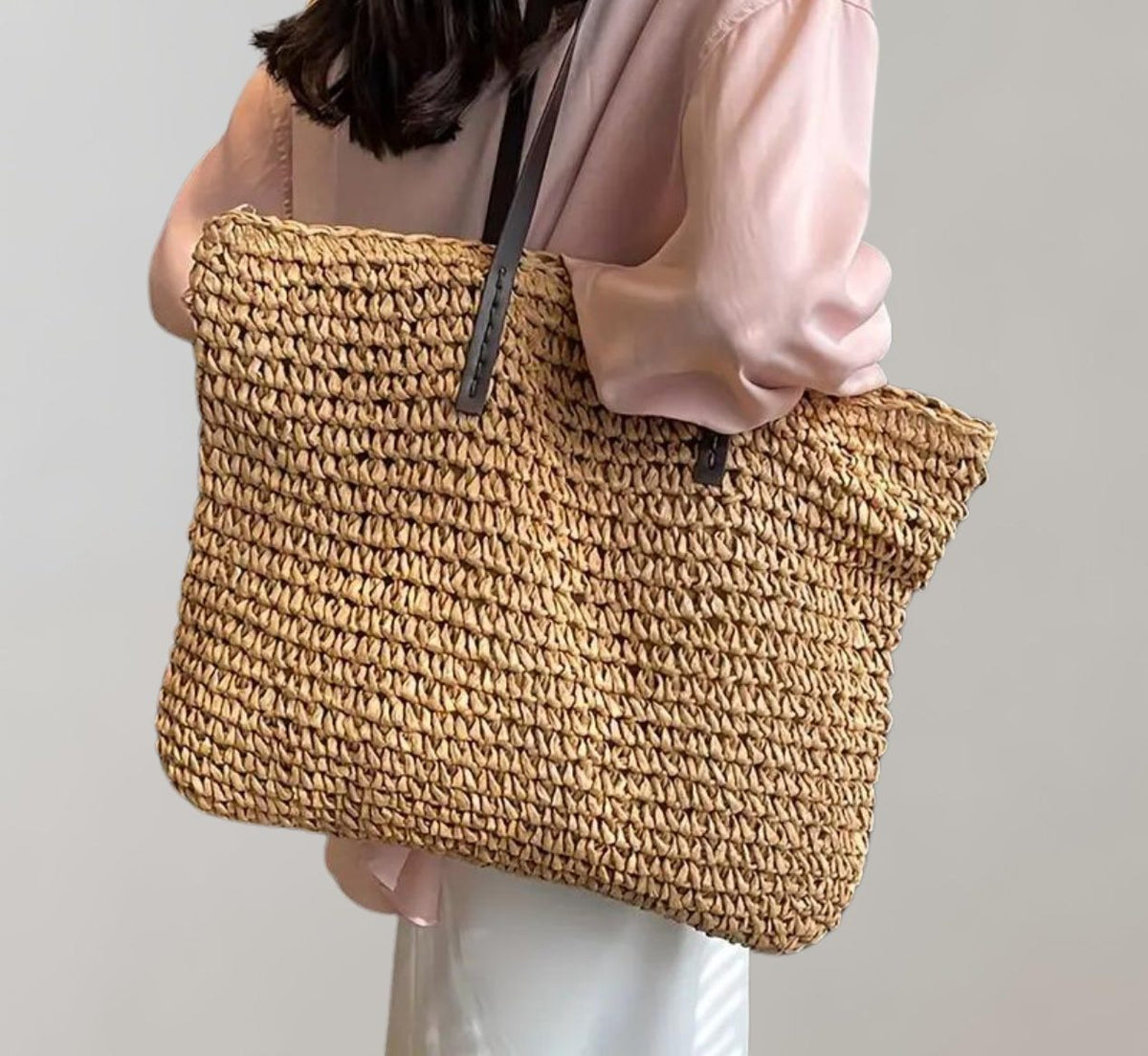 Woven straw tote bag in khaki – carried on the shoulder