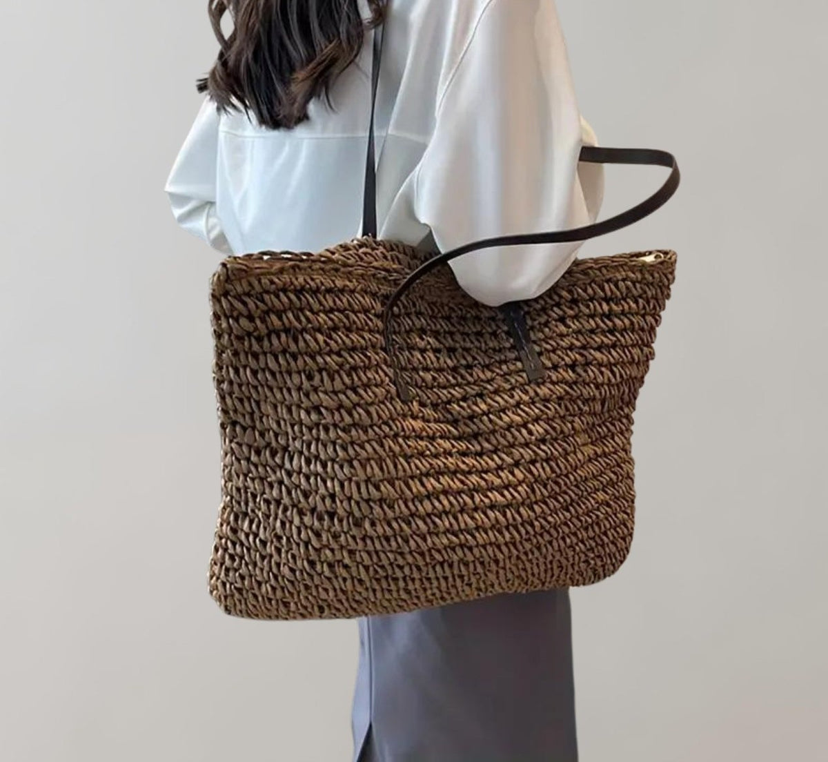 Woven straw tote bag in coffee – carried on the shoulder