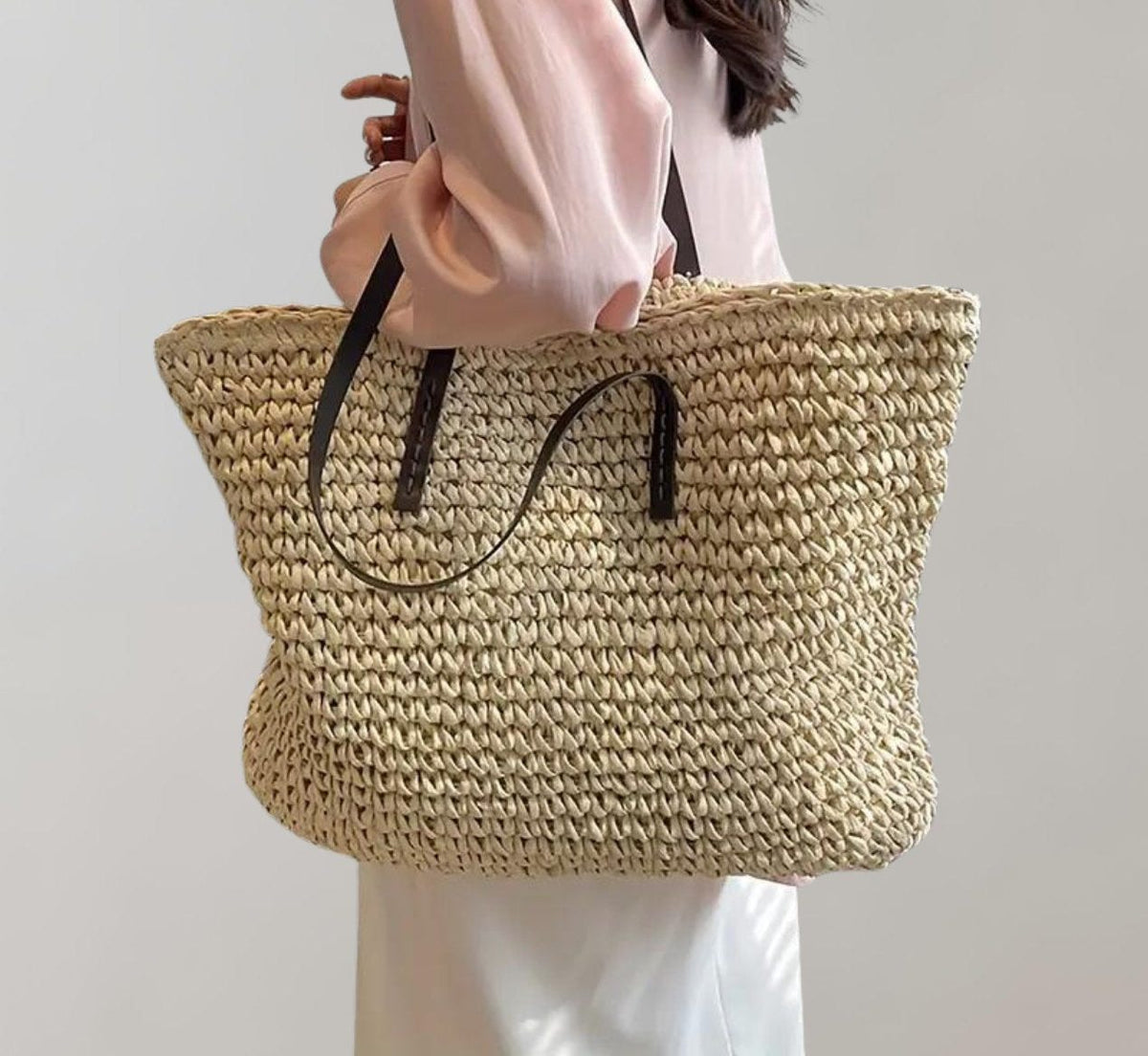 Woven straw tote bag in beige – carried on the shoulder